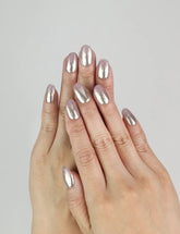 Model wearing Rose Haze Singapore press on nails with soft pink gradient shimmer in elegant coquette style